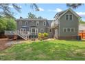 Expansive backyard features a wooden deck, patio area, and well-maintained lawn, perfect for outdoor entertaining at 6304 Ansley Ln, Raleigh, NC 27612