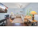 Inviting living area with hardwood floors, a large sectional sofa, and a wall-mounted TV at 6729 Osprey Landing Dr, Wendell, NC 27591