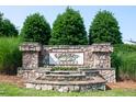 Stone community sign with Edgemont Landing inscription surrounded by tiered landscaping at 6729 Osprey Landing Dr, Wendell, NC 27591