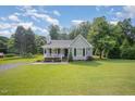 Inviting single Gathering home with well-manicured lawn and mature trees in the background at 701 Creekside Dr, Clayton, NC 27520