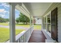 Inviting covered front porch with wooden floors and white railing at 701 Creekside Dr, Clayton, NC 27520