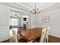 Elegant dining room view into spacious living room with fireplace at 8201 Ivymount Way, Raleigh, NC 27613