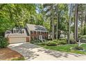 Charming two-story brick home featuring a two-car garage, dormer windows, and professionally landscaped front yard at 8508 Zinfandel Pl, Raleigh, NC 27615