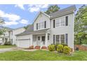 Beautifully landscaped two-story home with a well-manicured lawn, black shutters and an attached garage at 8912 Erinsbrook Dr, Raleigh, NC 27617