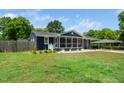 Beautiful house exterior with a screened in porch, side yard, and a well maintained lawn at 914 Forest Dr, Garner, NC 27529