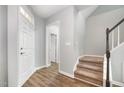 Inviting entryway with hardwood floors, a staircase, and a view into other rooms at 9612 Treymore Dr, Raleigh, NC 27617