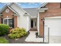 Close-up of the front exterior showcasing the entrance, brick accents, and landscaping at 9612 Treymore Dr, Raleigh, NC 27617