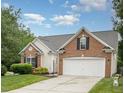 Lovely home exterior with attached garage, manicured lawn, and beautiful architectural details at 9612 Treymore Dr, Raleigh, NC 27617