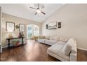 Bright living room with hardwood floors, a ceiling fan, large windows, and a comfortable sectional sofa at 1004 Lake Michael Way, Mebane, NC 27302