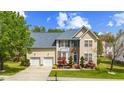Charming two-story home featuring manicured lawn, two-car garage, and inviting curb appeal at 1012 Delta River Way, Knightdale, NC 27545