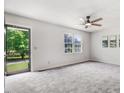 Spacious living room boasts a ceiling fan, plush carpet, and natural light from exterior at 103 Val Del Ct, Garner, NC 27529