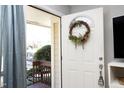 Inviting front door with a wreath, and a glimpse of the entryway's bright interior at 103 Westview # H, Carrboro, NC 27510