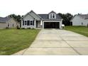 Inviting single-Gathering home with well-maintained lawn, an attached garage, and a classic gray exterior at 104 Oakfield Trace Dr, Four Oaks, NC 27524