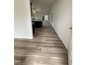Spacious hallway with modern flooring, leading to the living spaces and filled with natural light at 104 Oakfield Trace Dr, Four Oaks, NC 27524