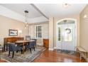 Cozy dining area with hardwood floors and elegant decor, adjacent to front entryway at 109 Jasmine Rose Ct, Holly Springs, NC 27540