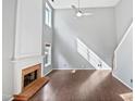 Bright open living room with fireplace, high ceilings, and hardwood floors at 117 Brierridge Dr, Apex, NC 27502