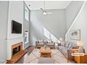 Bright living room with fireplace, high ceilings, and comfortable seating at 117 Brierridge Dr, Apex, NC 27502