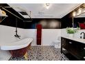 Stylish bathroom boasts a clawfoot tub, decorative tile floor, and black and white accents at 1209 Lochcarron Ln, Cary, NC 27511