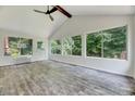 Bright sunroom with vaulted ceiling, large windows, and wood-look floors at 1209 Lochcarron Ln, Cary, NC 27511