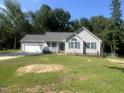 Charming single-story home with a two-car garage, blue shutters, and a cozy front porch at 125 Tast Dr, Wendell, NC 27591