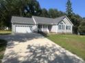 Charming single-story home with a two-car garage and a well-manicured front lawn at 125 Tast Dr, Wendell, NC 27591