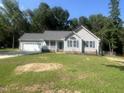 Charming single-story home with a two-car garage, blue shutters, and a cozy front porch at 125 Tast Dr, Wendell, NC 27591