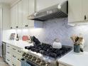 Close up of the kitchen featuring stainless steel appliances and custom herringbone backsplash at 129 Grande Dr, Morrisville, NC 27560