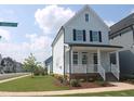 Corner view of a two-story home with well-manicured lawn and tidy landscaping along the sidewalk at 1534 Millrock Trl, Wendell, NC 27591