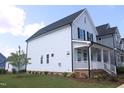 View of the rear of the house, showcasing the light blue siding and well-kept green grass at 1534 Millrock Trl, Wendell, NC 27591