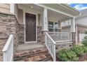 Close-up of the front porch with stone detailing and a welcoming front door at 216 Pondside Dr, Apex, NC 27539