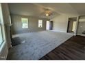 Spacious living room featuring plush carpeting, a fireplace, and plenty of natural light at 233 Constellation Ct, Benson, NC 27504