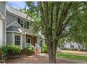 Well-maintained townhome with brick and siding exterior, complemented by mature trees and landscaping at 2623 Broad Oaks Pl, Raleigh, NC 27603