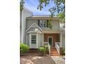 Inviting townhome with brick facade, white trim, and well-manicured front yard at 2623 Broad Oaks Pl, Raleigh, NC 27603