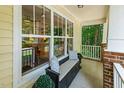 Inviting porch featuring a cozy bench with decorative pillows, ideal for relaxing and enjoying the outdoors at 2721 Rustic Brick Rd, Raleigh, NC 27603