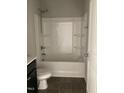 Clean bathroom featuring a shower-tub combo with a white surround and dark vanity at 305 Theys Mill, Fuquay Varina, NC 27526