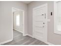 Light and airy entryway with gray walls, luxury vinyl flooring, and white doors at 308 Caswell St, Burlington, NC 27217
