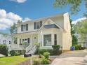 View of home with covered front porch, mature landscaping and visible driveway at 3303 Glen Currin Dr, Raleigh, NC 27612