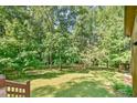 Enjoy lush views of the backyard with mature trees from the covered patio at 36 Birnamwood Dr, Chapel Hill, NC 27516