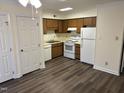 Bright kitchen with white appliances and wood cabinets at 3601 Helix Ct # 301, Raleigh, NC 27606
