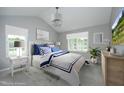 Serene bedroom with plush bedding, ample natural light, a stylish chandelier, and soft neutral tones at 3684 Ben Mil Ct, Franklinton, NC 27525