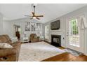 Cozy living room featuring a fireplace, neutral decor, and a ceiling fan for added comfort at 4524 Sugar Maple Rd, Oxford, NC 27565