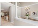 Elegant dining room with chandelier, tall ceilings, hardwood floors and view of living room at 4724 Ludwell Branch Ct, Raleigh, NC 27612