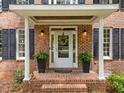 Inviting brick entryway with a white front door and decorative wreath at 5109 Makena Dr, Raleigh, NC 27615