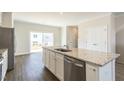 Kitchen featuring a large island with granite countertops, stainless steel appliances, and a sliding door at 5330 River Reach Dr, Raleigh, NC 27616