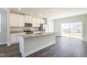 Modern kitchen with granite countertops, stainless steel appliances, and a breakfast bar at 5334 River Reach Dr, Raleigh, NC 27616
