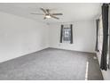This bright, spacious bedroom features new carpeting, a ceiling fan, and two large windows at 555 Dacian Rd, Raleigh, NC 27610