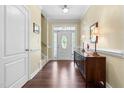 Welcoming foyer with hardwood floors, elegant lighting, and a decorative front door at 59 Carrousel Ct, Angier, NC 27501