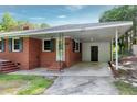 Close-up of a brick home featuring a useful carport and covered entry at 603 Nellane Dr, Garner, NC 27529