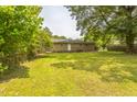 Spacious backyard featuring a well-maintained lawn and mature trees, perfect for outdoor activities at 605 Sexton Ave, Zebulon, NC 27597
