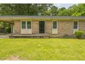 Front view of a single story brick house featuring a covered porch and well-maintained lawn at 605 Sexton Ave, Zebulon, NC 27597